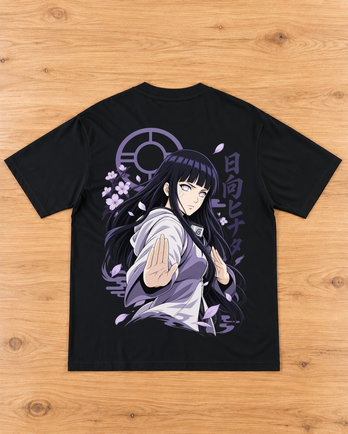 Back of a black T-shirt with a lavender and white anime-style female warrior graphic, blossoms, drifting petals and purple lettering.