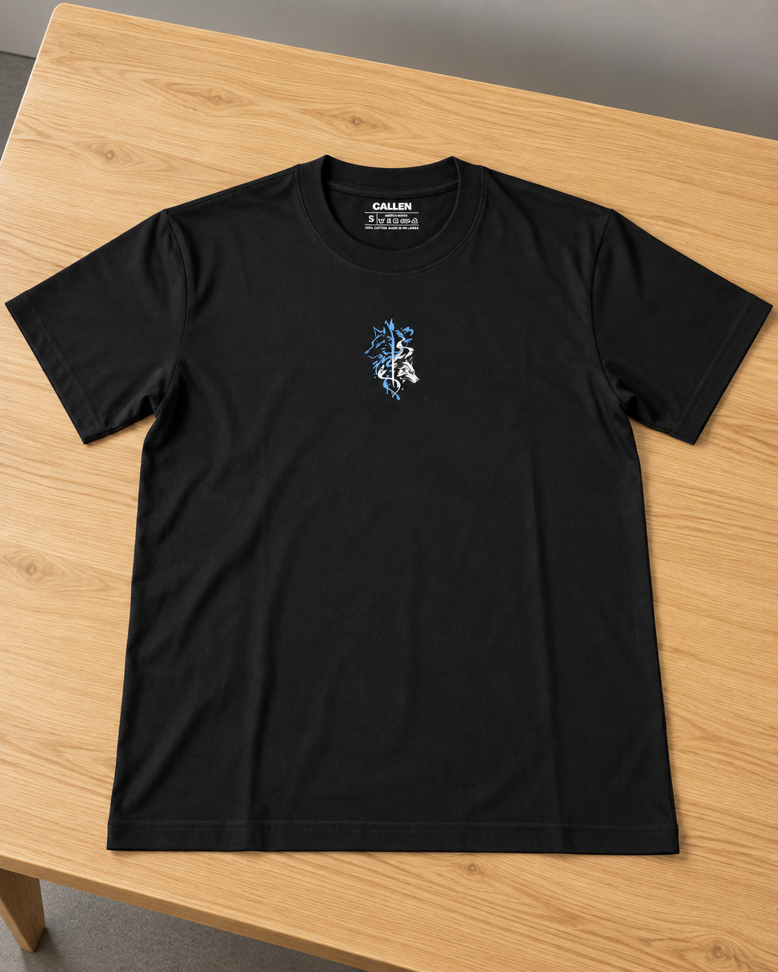 Back of black relaxed-fit T-shirt with blue-and-white figure and shadow wolf illustration